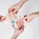 Przekazywanie banknotów euro z rąk do rąk